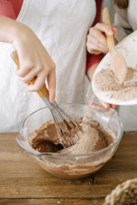  Brownie batter in a mixing bowl with a whisk