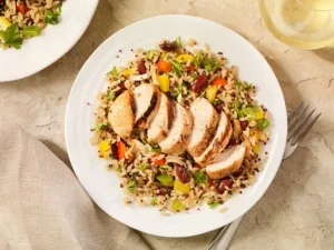 A colorful lunch plate with grilled chicken, quinoa, and steamed vegetables