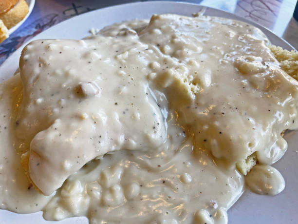 Creamy sausage gravy served over warm, flaky biscuits on a plate