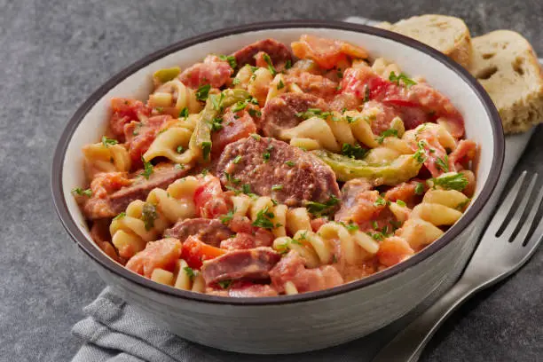 Pasta Fagioli served with ditalini, beans, and sausage, topped with Parmesan and parsle