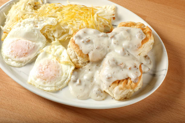 Biscuits and gravy served on a plate with sausage gravy