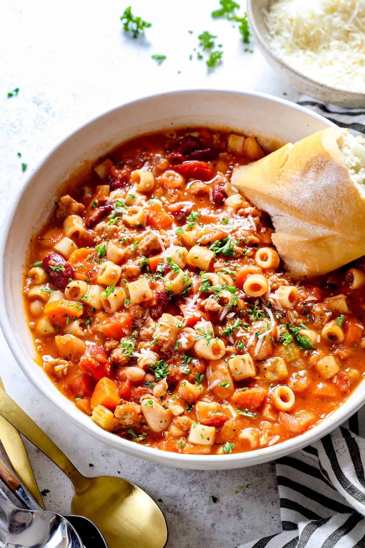 Bowl of pasta fazool with chicken, beans, and fresh herbs