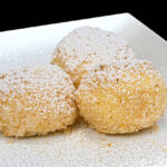 Sweet Bisquick dumplings with cinnamon sugar topping on a plate.