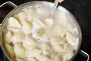 Dumplings floating at the surface of boiling water.