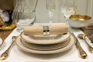 Elegant table setting with plates, utensils, and glasses arranged for a formal meal