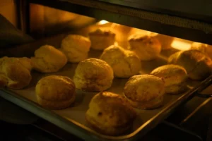 Golden brown biscuits fresh out of the oven on a baking tray.