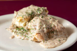 Gourmet biscuits and gravy served with fresh herbs