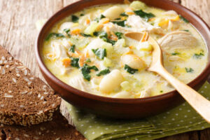 Herb-infused Bisquick dumplings served in a bowl with garnish.