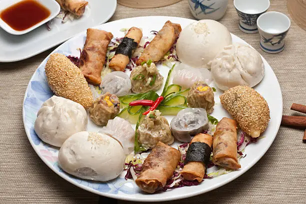 A selection of dumplings—steamed, boiled, and pan-fried—on a serving platter.