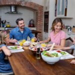 A family enjoying a meal together at a beautifully set dining table