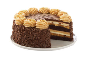 A rich layered cheesecake from Cheesecake Factory, featuring chocolate cake, Reese’s peanut butter filling, and chocolate shavings on the sides, topped with peanut butter frosting swirls.