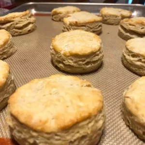 Freshly baked 3 ingredient biscuits on a baking tray.