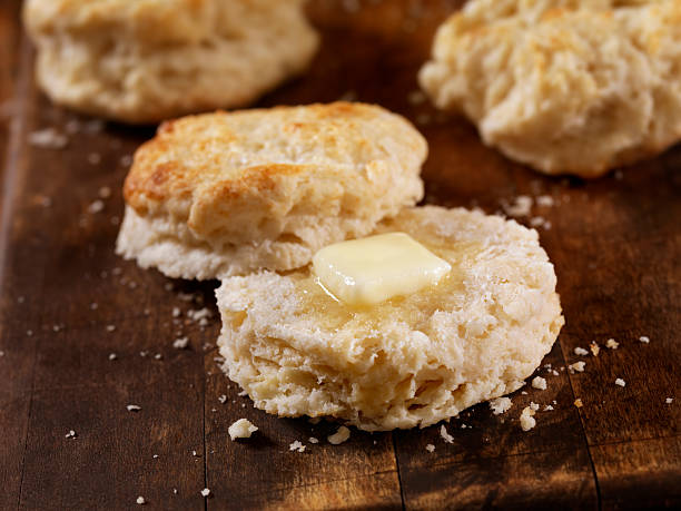 A stack of golden brown 3 ingredient biscuits with melting butter on top.