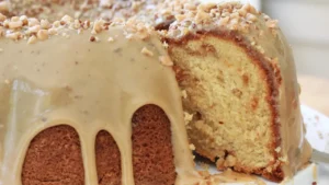 A moist Bundt cake with caramel glaze and chopped nuts, enhanced with brown sugar and flavored extracts