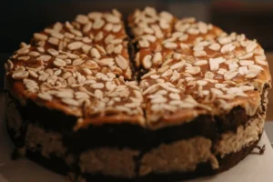 A delicious chocolate cake topped with caramel and peanuts, showcasing a creative twist to a boxed cake mix.