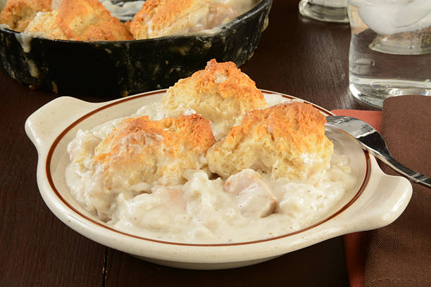 A plate of Southern biscuits and gravy with a fork