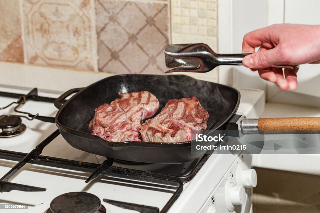 Sizzling steak in a cast iron pan with a golden crust